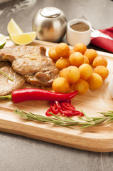 Croquettes with pork served on a wooden tray