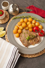Croquettes with pork served on a wooden tray