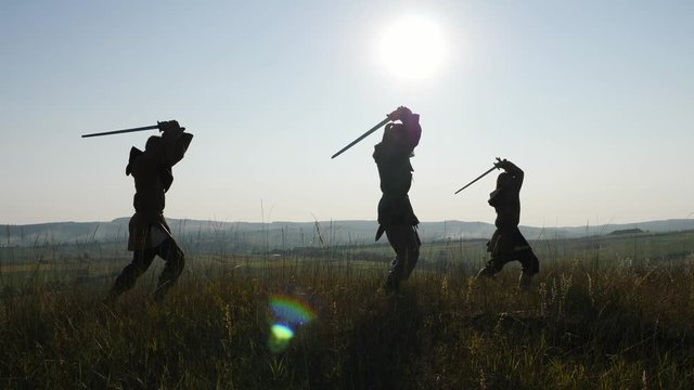 Silhouette of a Vikings practicing using the sword for battle.