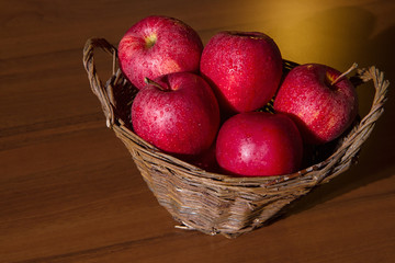 Red apples in a wicker basket