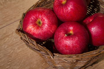 Red apples in a wicker basket