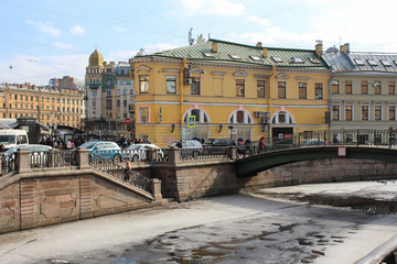 Historical buildings and the Hay bridge over the Griboedov Canal in the old shopping district Sennaya Ploshchad in St. Petersburg in the early spring. They sold hay a hundred years ago.