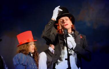  girl in tuxedo and hat singing on stage © andrys lukowski
