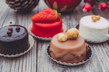 An array of Christmas desserts with colorful   , on wooden board