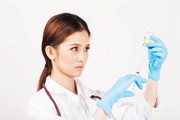 Fototapeta premium Syringe with vial on hands in a latex glove of a female doctor,administer the injection.