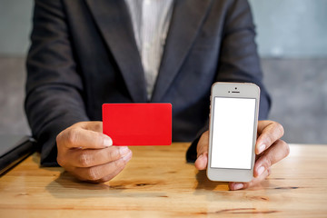 Businessmen holding red credit card and mobile phones. Online shopping concept