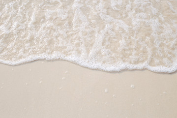 The movement of the waves on the sand is smooth and fine for  background,