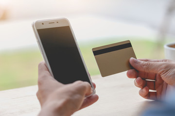 Man using mobile smartphone and credit card. Shopping Online