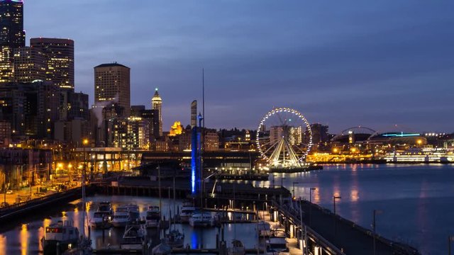Time lapse video of a colorful and vibrant sunrise overlooking the Pier and Ferris Wheel in Downtown Seattle, Washington, United States of America.
