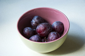 Bowl with fresh plums