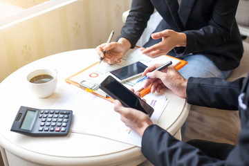 Teamwork process, business people working in the office discussing documents and ideas at meeting, Show the data from smart phone in business meeting