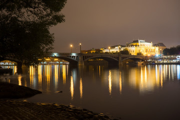 Fototapeta premium Manes bridge in Prague, Czech Republic. Light of lanterns reflected in the Vltava River