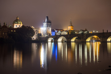 Fototapeta na wymiar Charles Bridge and the Mill peninsula at night. Czech Republic