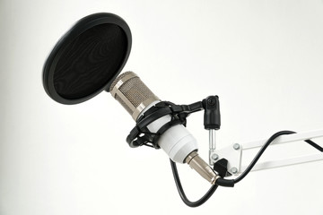 Professional condenser studio microphone on the white background
