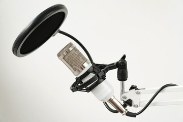 Professional condenser studio microphone on the white background