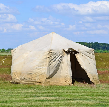 Military tent on the meadow in summer time