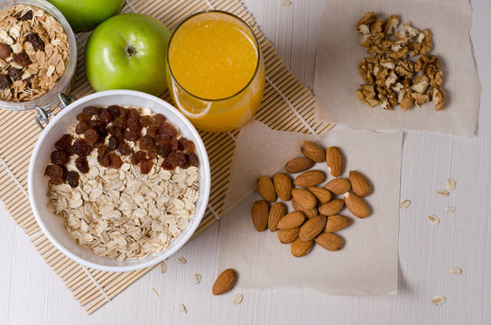 Healthy Breakfast. Granola, apples, bananas, oatmeal with raisins, honey, nuts. Measuring tape