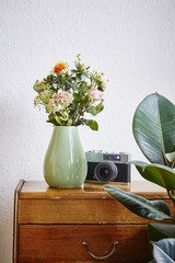 vintage interior design green vase with rose flowers
