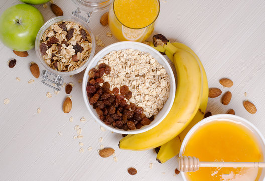 Healthy Breakfast. Granola, apples, bananas, oatmeal with raisins, honey, nuts. Measuring tape