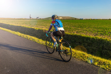 Fototapeta na wymiar Cycling on a road bike around the Markkleeberger Lake near Leipzig, Germany