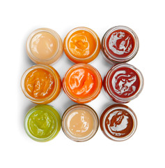 Jars with different baby food on white background