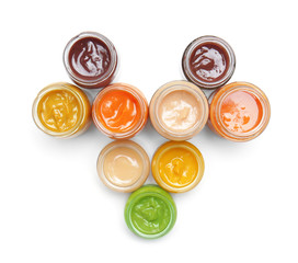 Jars with different baby food on white background