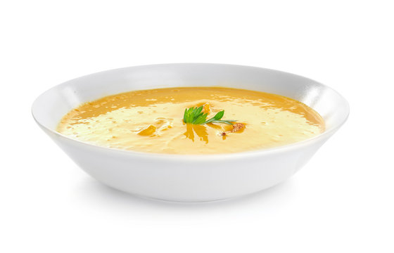 Portion of fresh homemade lentils cream soup in plate on white background