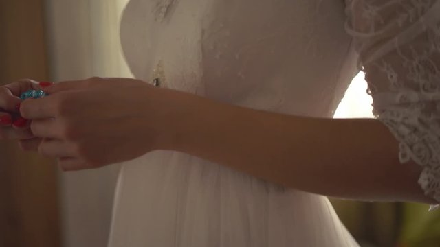 hands of the bride close-up. preparation of the bride for the solemn moment. happy wedding day. 4k