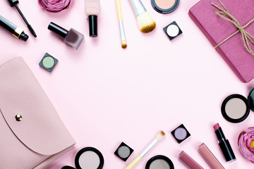 Naklejka premium Woman make up products and accessories on pastel background