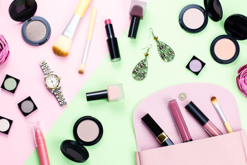 Woman make up products and accessories on pastel background