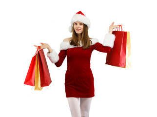 Beautiful woman in Santa Claus clothes holding shopping bags on white background