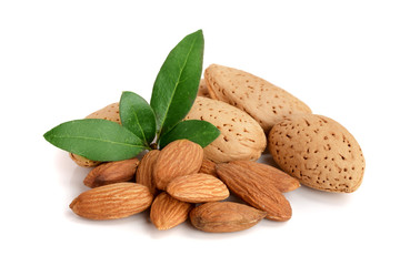 Group of almond nuts with leaves isolated on white background