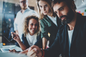 Group of entrepreneurs are looking for a business solution during work process at office.Business people meeting concept.Blurred background.Horizontal.