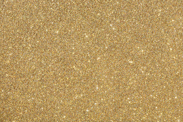 Golden (yellow) glitter background. Sparkle texture. Abstract background for New Years or Christmas holiday