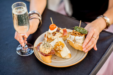 Beautiful and colorful set of pinchos, traditional spanish snack related to tapas, with glass of...