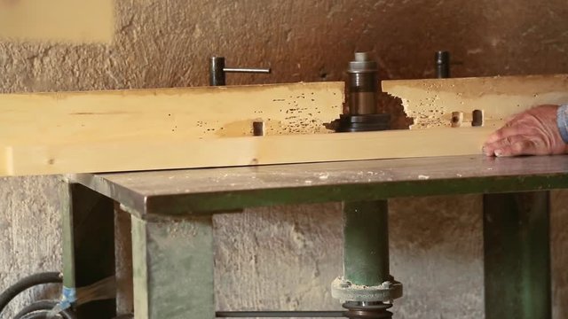 Gouging the wooden square beam on machine