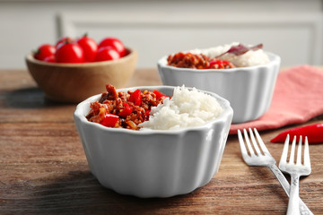 Chili Con Carne with rice in bowl on table