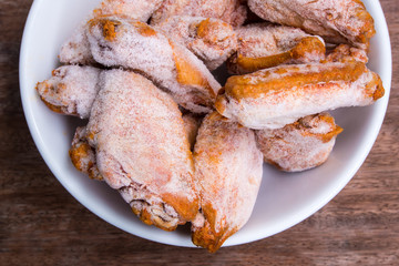 Some pieces of frozen fried chicken wings