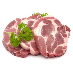 Raw pork neck chop meat with parsley herb leaves garnish isolated on white background cutout