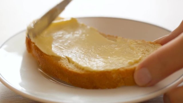 Spreading butter on bread 