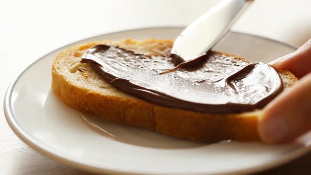 Spreading chocolate pasta on bread