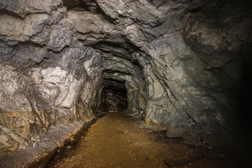 Old abandoned underground ore mica  mine shaft tunnel