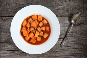 Kürbis und Bratwurst als Gulasch mit Löffel in Silber