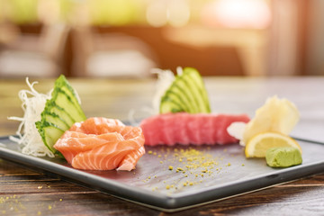 Fresh fish sashimi set. Raw salmon and tuna sashimi served with cucumber, salmon and wasabi.
