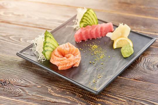 Beautifully served fresh fish sashimi set. Salmon and tuna raw sashimi on wooden table. Japanese food, sashimi set.