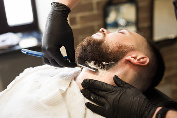 Man getting haircut by hairstylist at barbershop