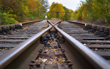 Rails to infinity.Hopeless post apocalyptic landscape. Cemetery of abandoned broken trains.
