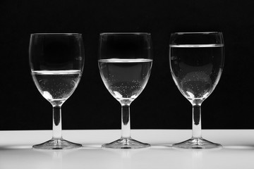 Transparent glasses with water growing business chart.