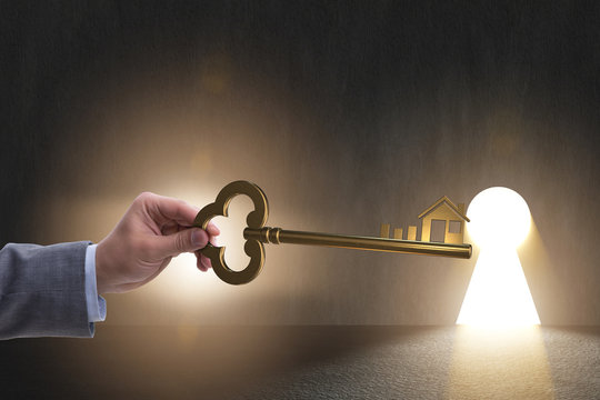 Businessman holding key in real estate concept - Powered by Adobe