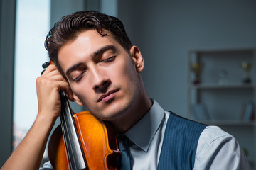Young musician man practicing playing violin at home © Elnur